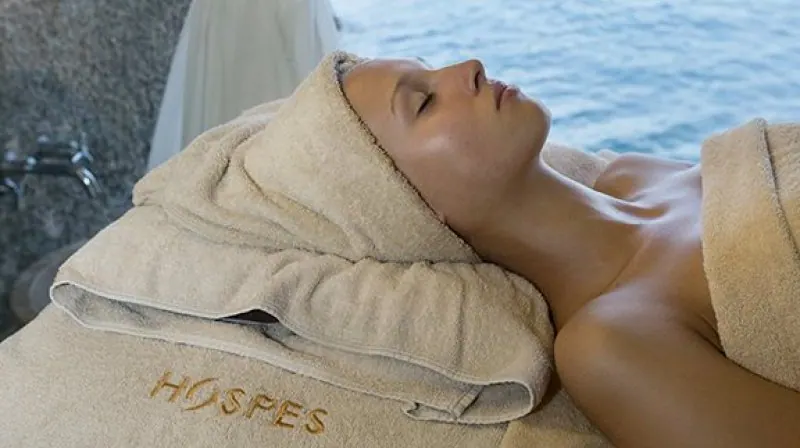 A woman relaxing at a luxury spa and enjoying a treatment.